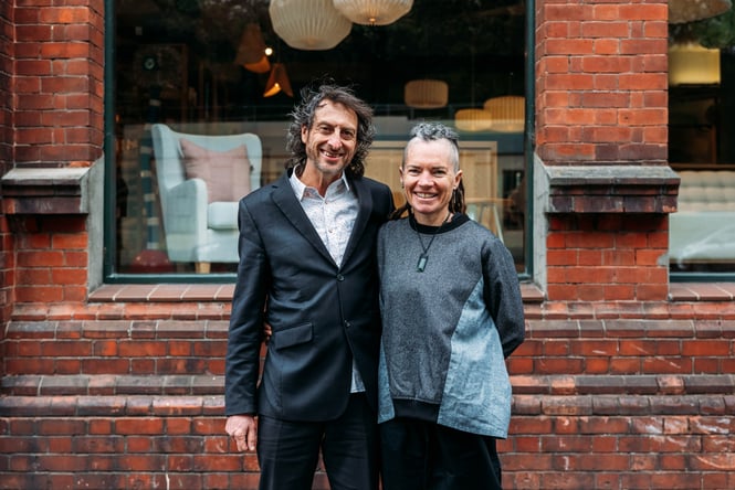 Two people smiling to camera.