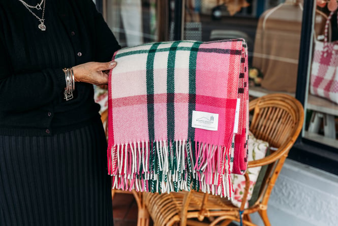 A pink tartan woollen blanket.