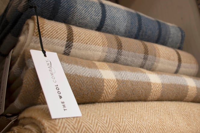 Tartan blankets folded in a stack.