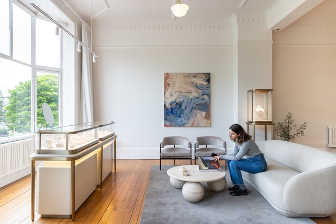 Customer sitting on the sofa in the Naveya & Sloane showroom.