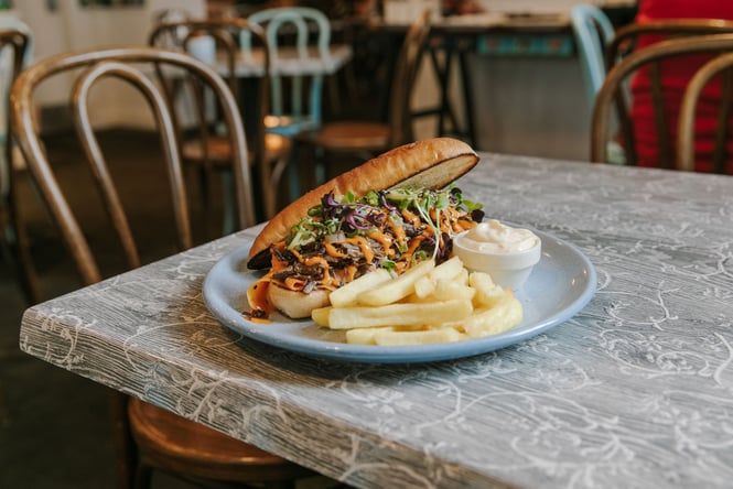 Plate of pulled brisket with fries on the side