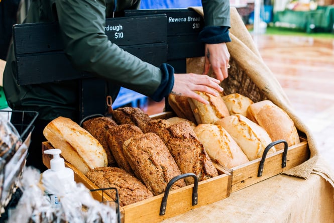 Fresh loaves of sourdough bread in crates at market