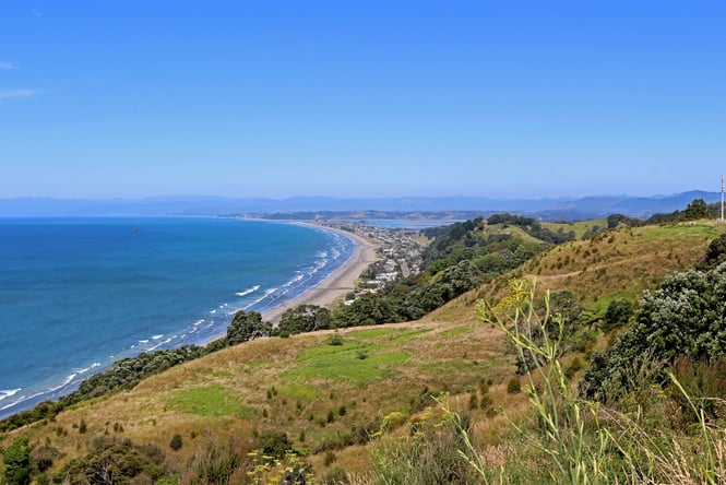 A view of Ōhope Beach on a sunny day.