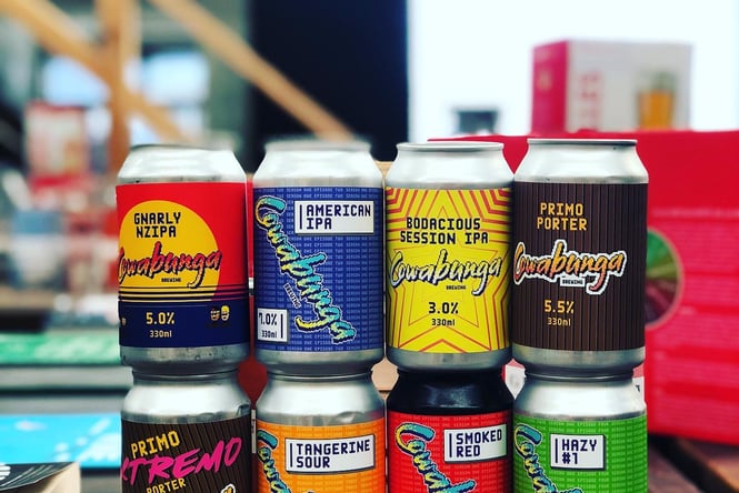 A tower of beer cans on the bar at the beer library.