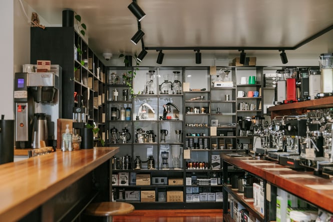 Coffee brewing equipment lined up on shelves inside C4 cafe in Christchurch.