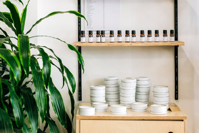 Candles and skincare testers on shelf