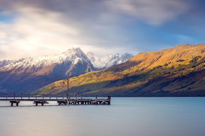 The sun shining down on the Southern Alps in the background to Glenorchy Wharf.