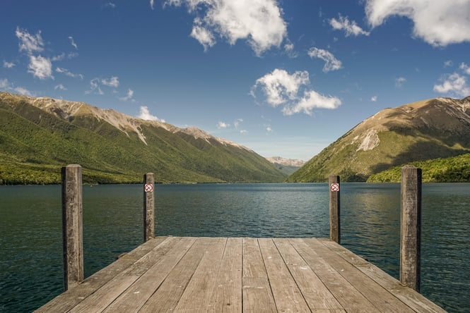 Lake Rotoiti on a cloudy day with the wharf in the foreground.