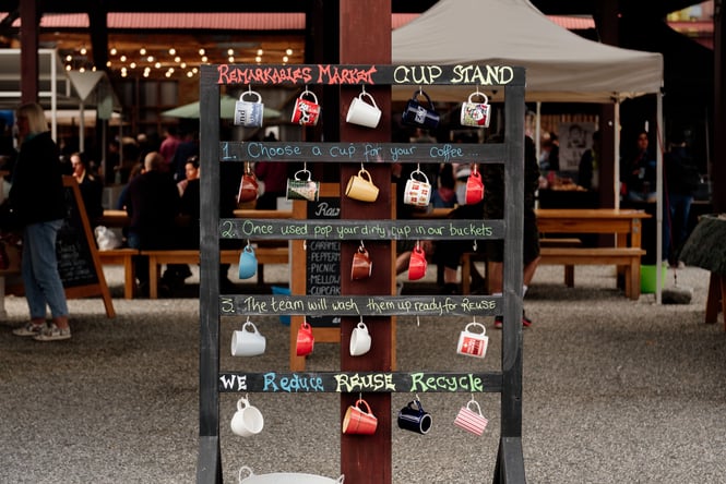 Ceramic cups hanging on a stand.