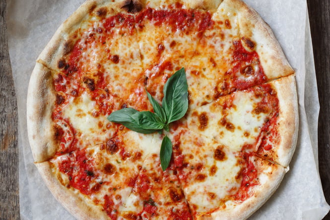 Tomato and cheese pizza on a table.