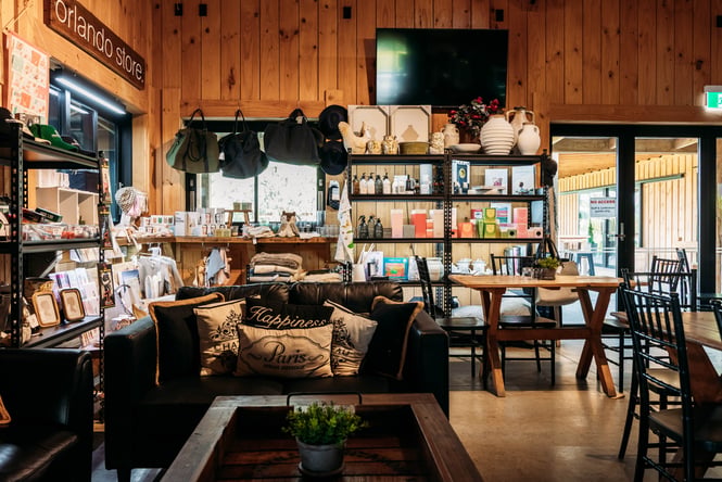 The wooden interior where there are tables and a counter.