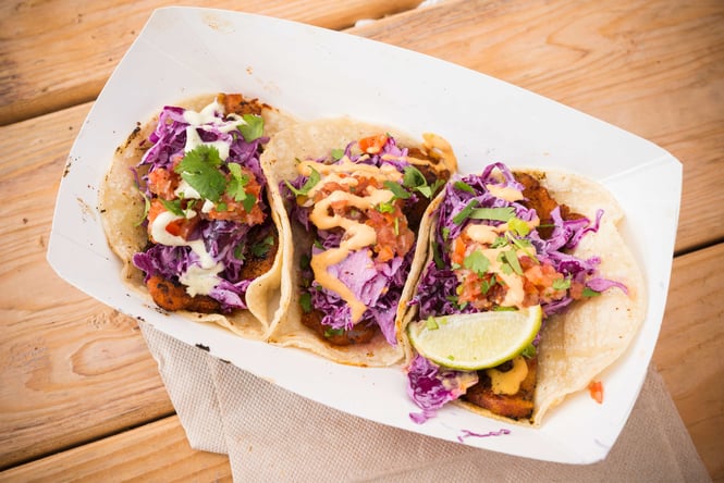 Three fish tacos on a plate.