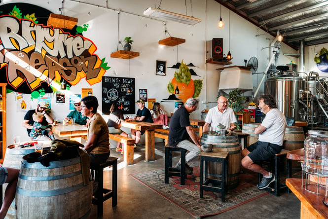 People sitting at tables at Rhyme x Reason.