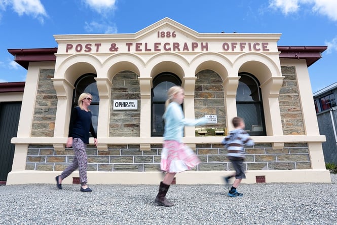 A family running outside the old post office.