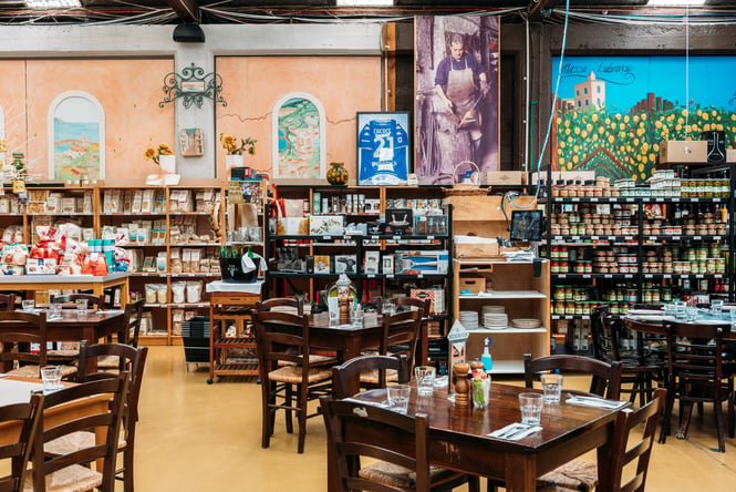 Cafe chairs and groceries on display inside La Bella Italia.