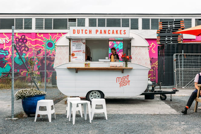 A little white food caravan selling Dutch pancakes.