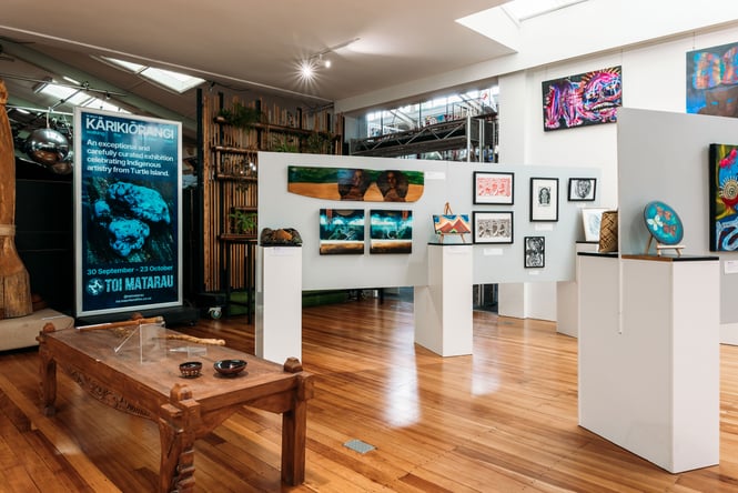 Māori works of art on display inside a gallery.