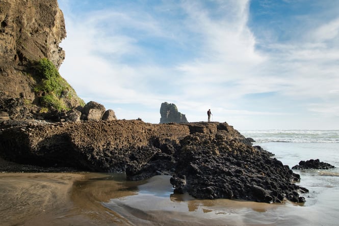A man standing on his own at Anawhata Beach.