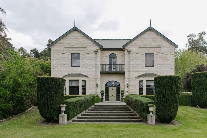 Outside view of the building and gardens at Casa Nova House in Ōamaru.