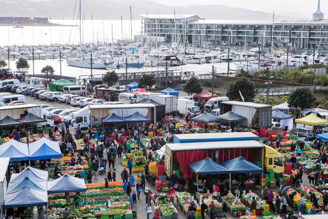 Stalls and market-goers at Harbourside Markets.