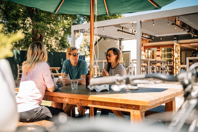 Three customers sit at an outdoor table at Gantley's Tavern.