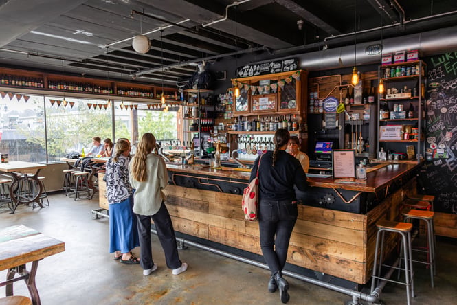 Customers standing at the bar at Smiths Craft Beer House.