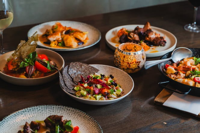 Multiple food dishes on the table at La Rumbla.