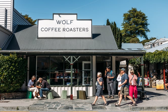 A group of customers by the front door at Wolf Coffee.