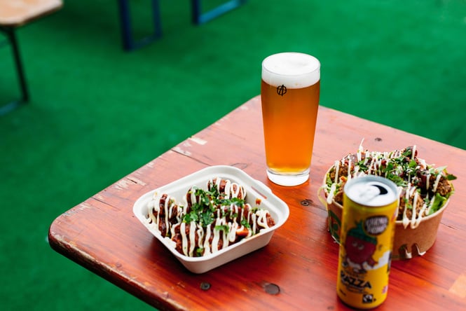 Beers and food dishes on the table at Abandoned Brewery.