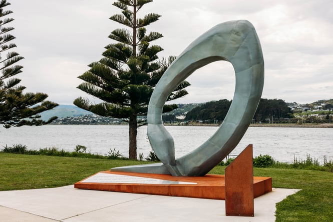 Large sculpture beside the water.