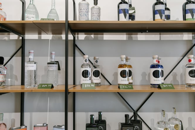 Bottles of gin lined up on shelves.