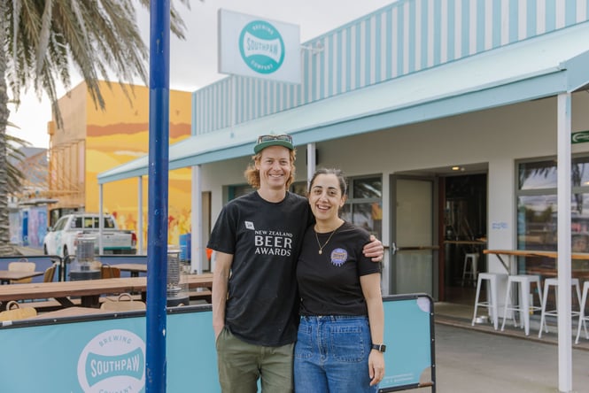 Portrait of Cam and Penny in front of Southpaw Brewing Company & Taproom
