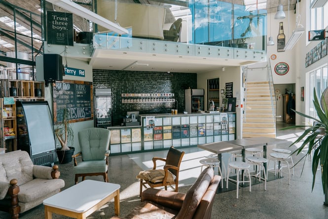 Downstairs seating area and bar counter of Three Boys Brewery's taproom in Christchurch