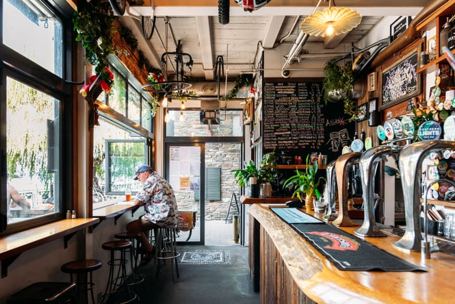 A man having a drink inside a bar.