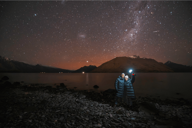Two people star gazing at night.