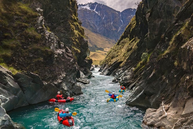 People kayaking down a river.