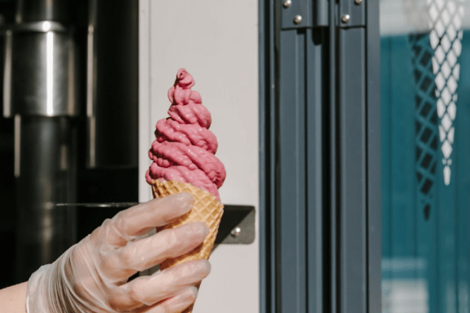 Hand holding a real fruit ice cream.