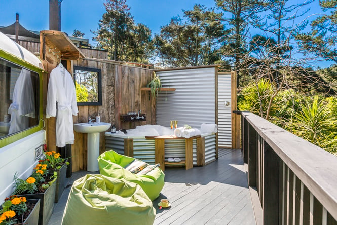 Outside area at Warblers Resort with an outdoor spa surrounded by native bush