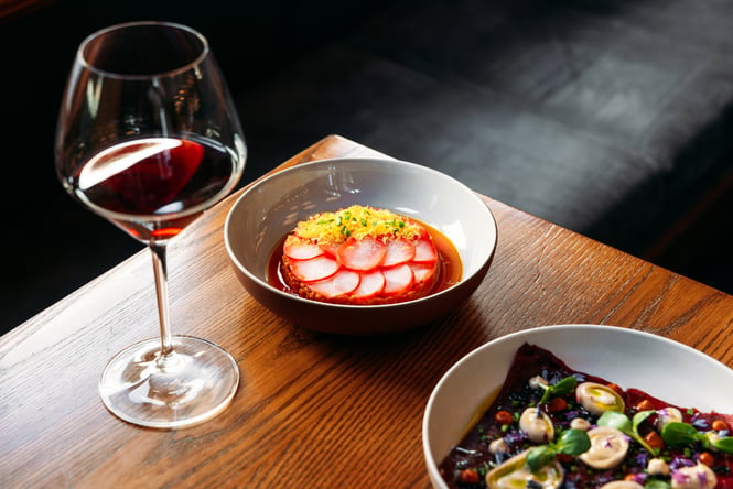 Food and wine on a table at Aosta Arrowtown.
