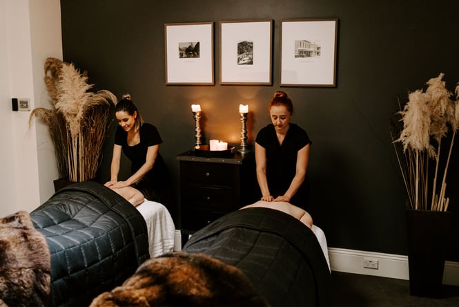 Two people receiving back massages.