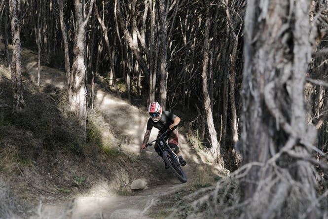 A mountain biker biking on a track.