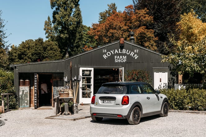 A Mini parked outside a farm shop.