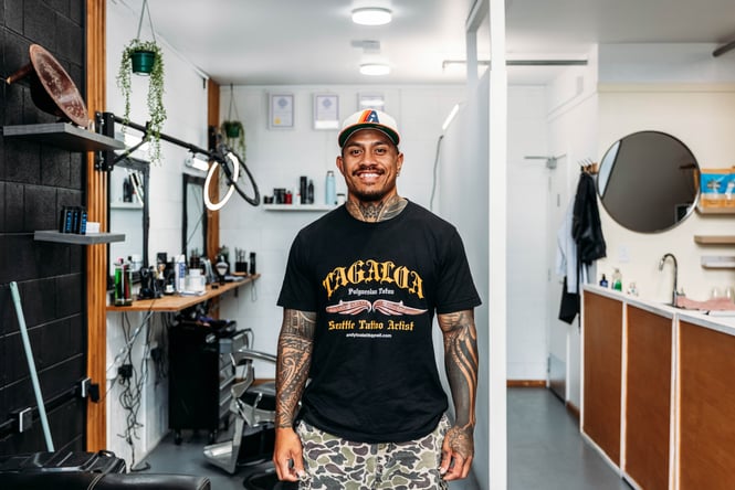 A tattooed man posing for camera.