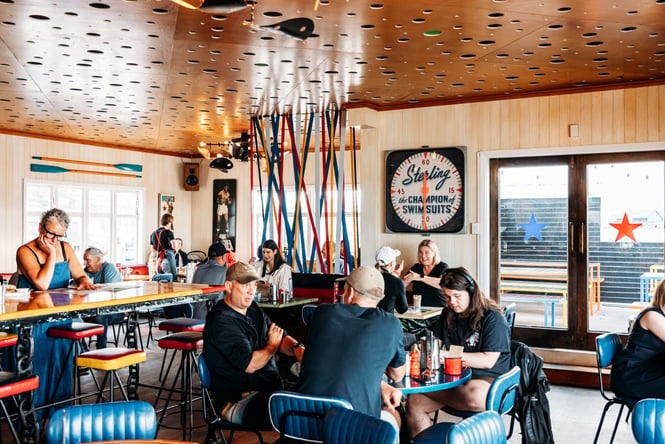People dining inside a busy cafe.