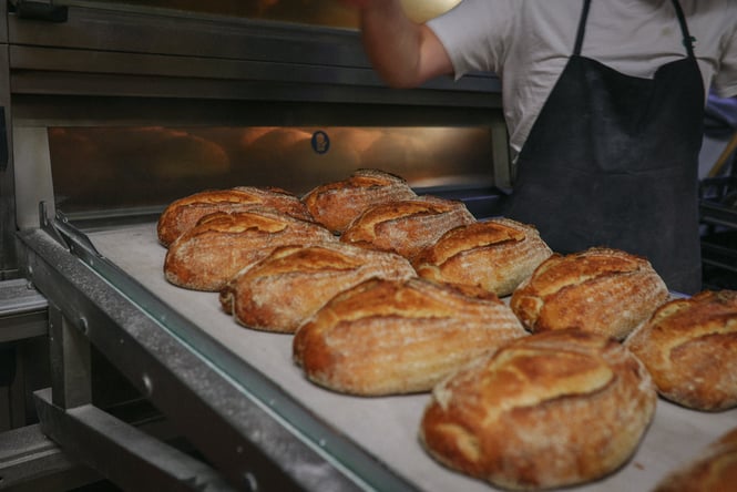 Fresh bread coming out of the oven at Grizzly Baked Goods.