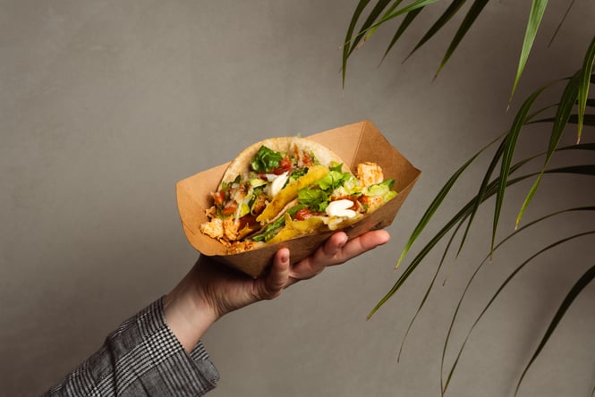 Customer holding a taco.