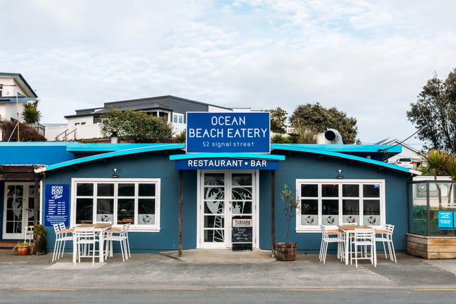Blue restaurant exterior of Ocean Beach Eatery.