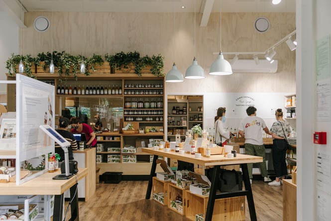 Busy interior with customers queuing at Barker's Foodstore.