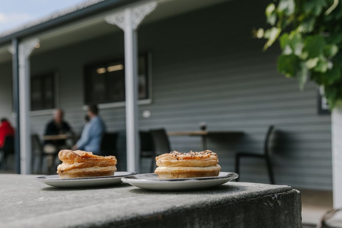 A couple of pies on plates at Fairlie Bakehouse.