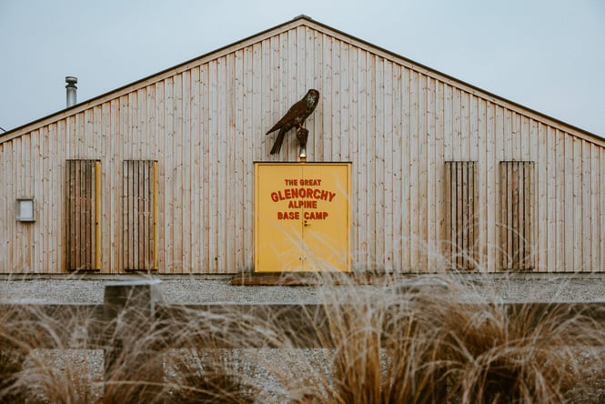 A yellow sign outside Base Camp in Queenstown.